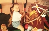 Julie N. Books Riding Carousel Horse as a Child